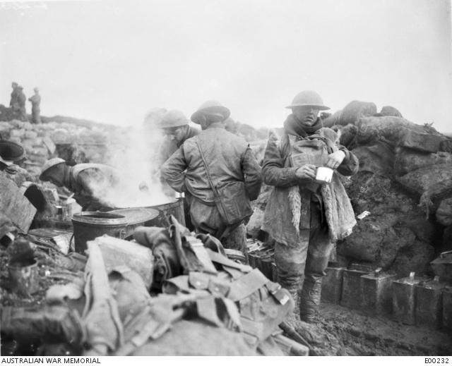 Men of the 10th Battalion enjoying a hot meal in the trenches, in the line at Eaucourt l'Abbaye, during the Somme advance. ©AWM E00232