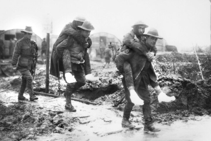 Australian ambulance men at Bernafay assisting their comrades, who are suffering from trench feet, to a transport which is to convey them to hospital. ©AWM E00081