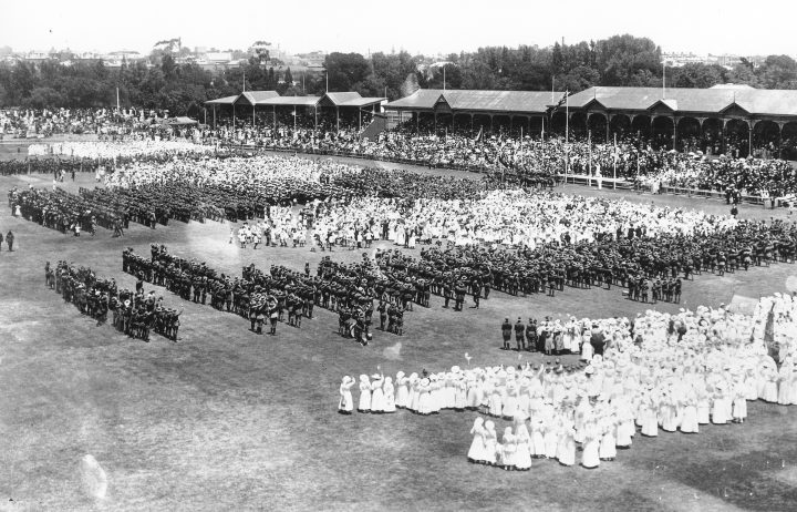 Australian troops and volunteer groups standing on an oval in Adelaide in 1918 to observe the Armistice