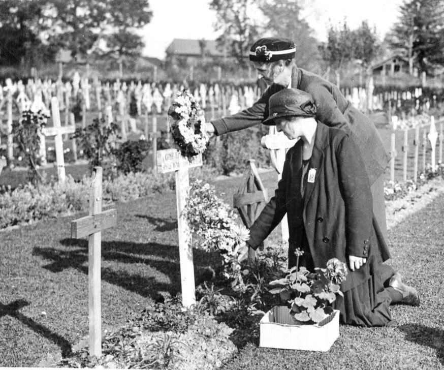 Two sisters laying flowers at the graveside
