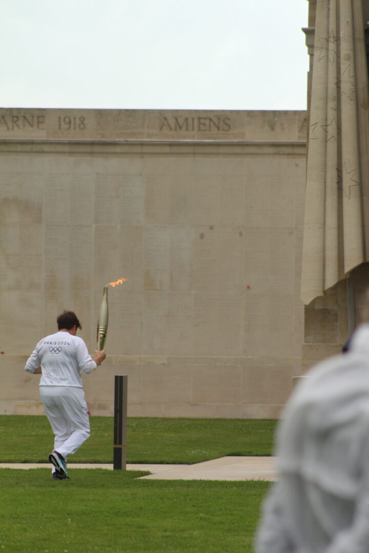 Floriane Bormans approaching the Memorial with the Olympic Torch.