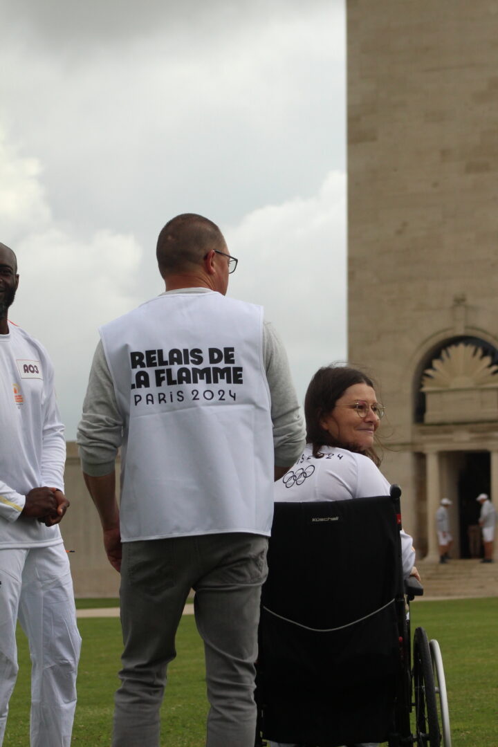 Torchbearer Adèle Lelong and other torchbearers in front of the Memorial tower.