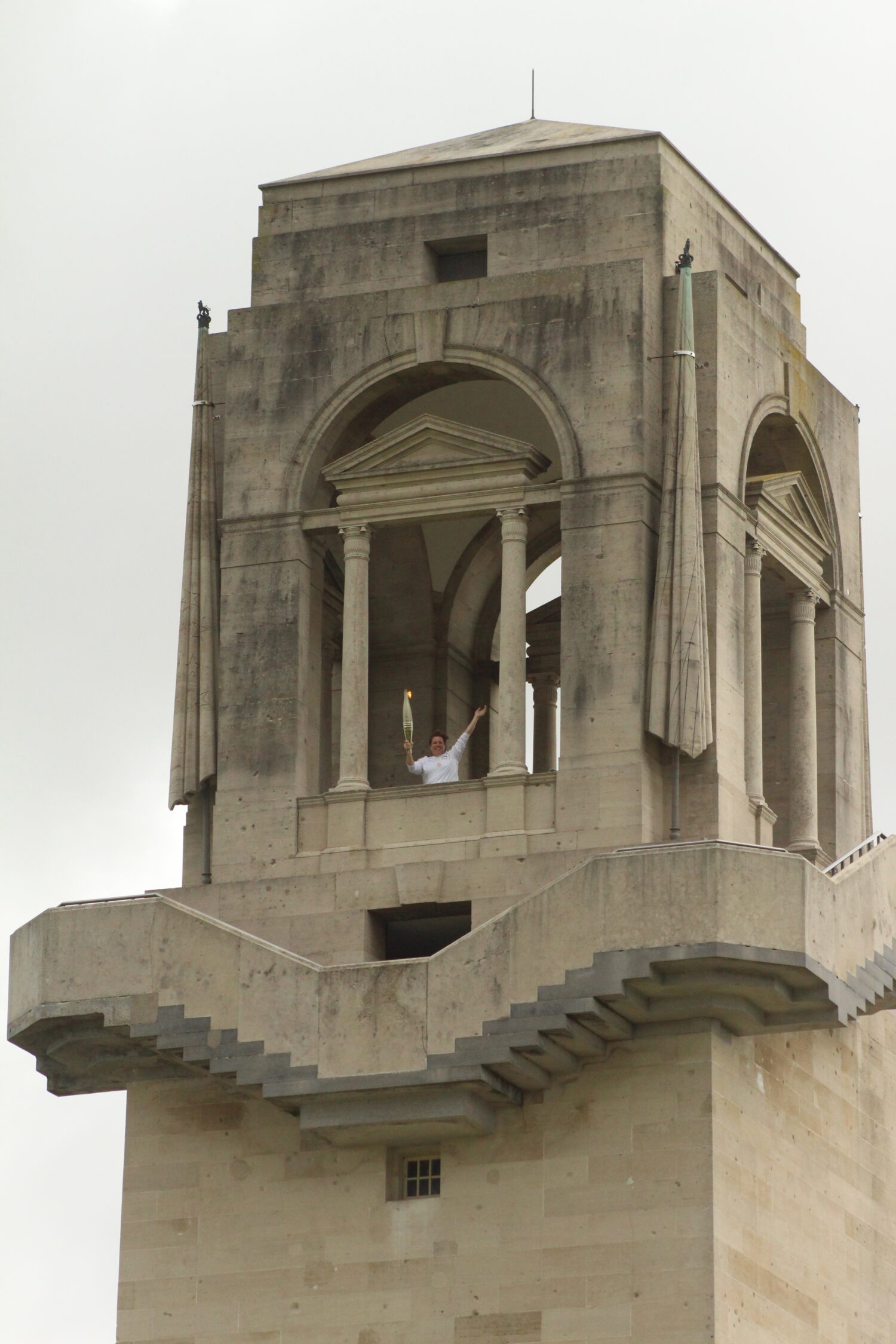 Floriane Bormans at the top of the Memorial Tower with the Olympic Torch