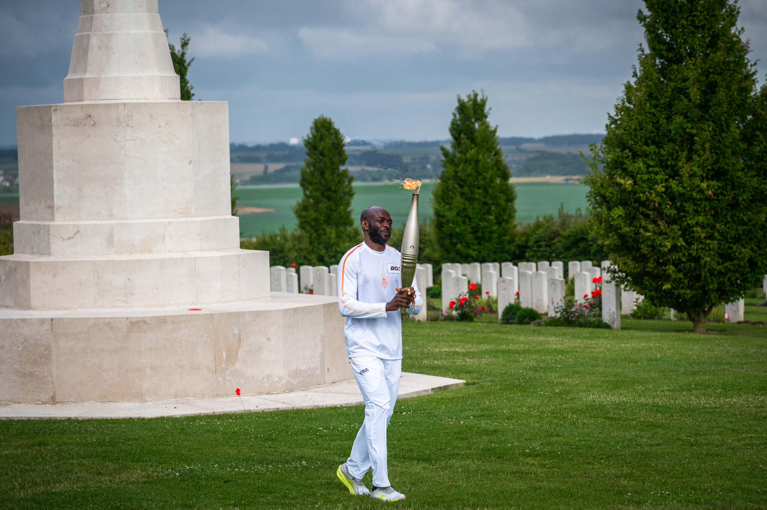 The third relay runner, Athos Felemou, carrying the Olympic Torch.