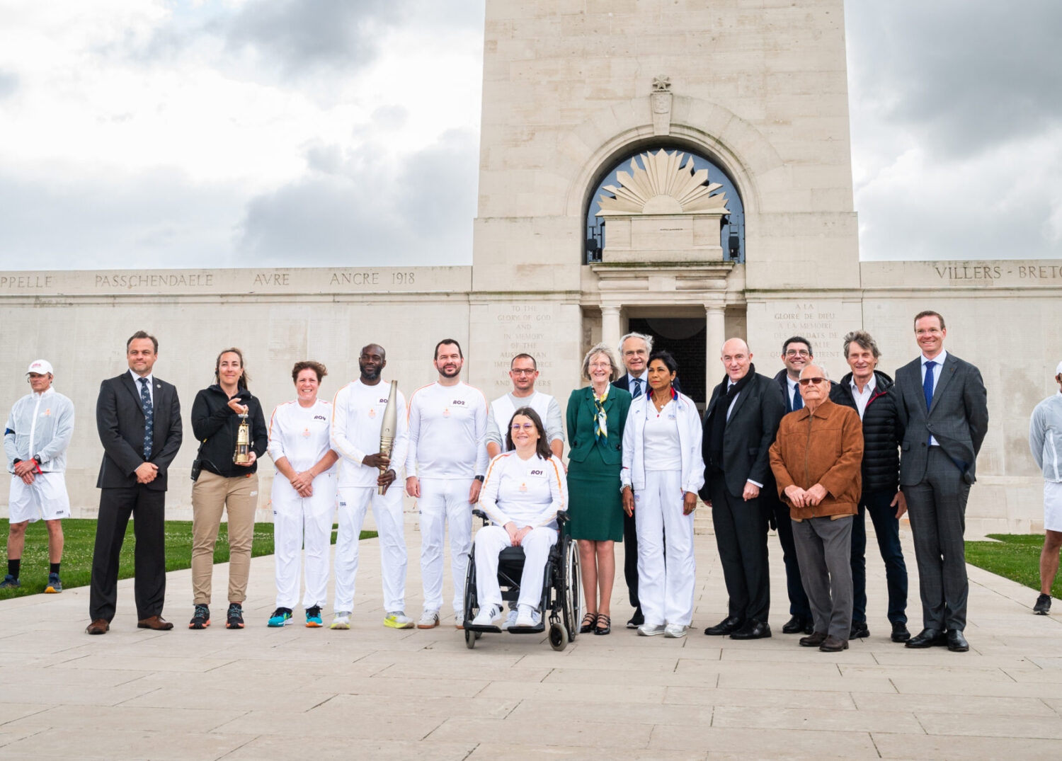 The torchbearers alongside the various officials present in front of the memorial