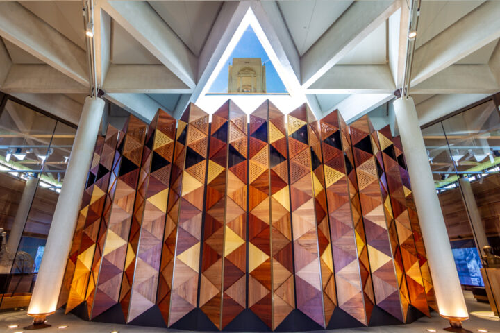 The timber wall of the Sir John Monash Centre foyer. The tower of the Australian National Memorial is visible through the oculus.