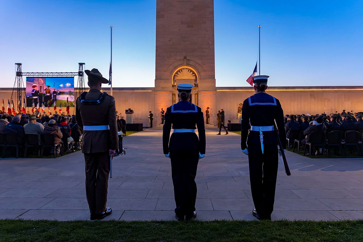 Three Australian soldiers standing before the Australian National Memorial at the end of the service.