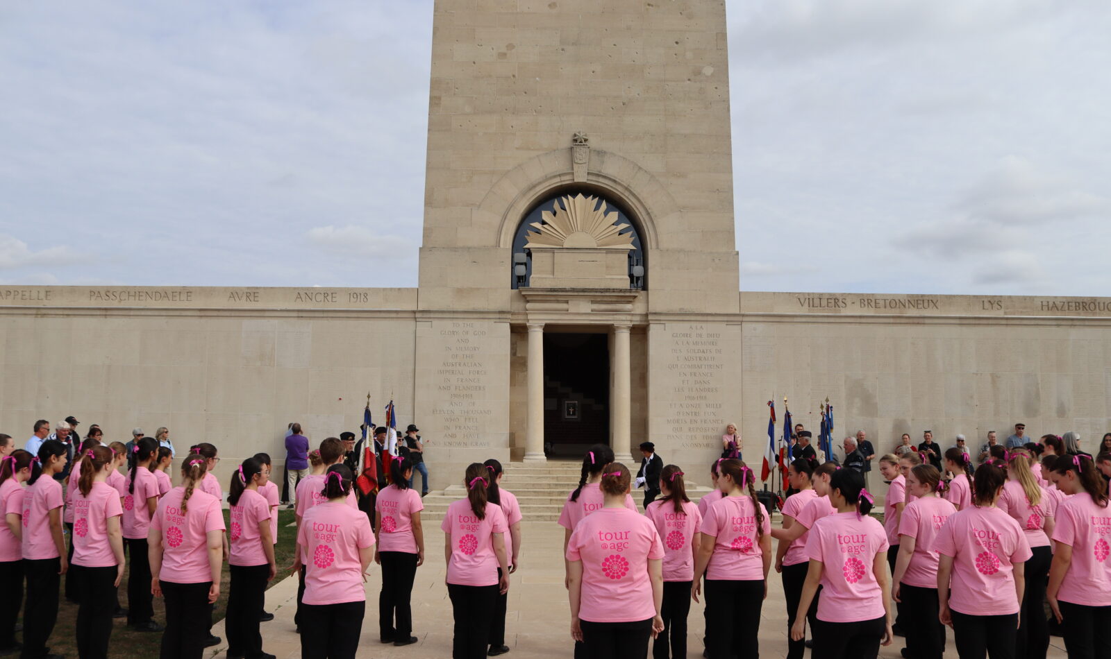 The singers and flag-bearers gathered at the foot of the memorial