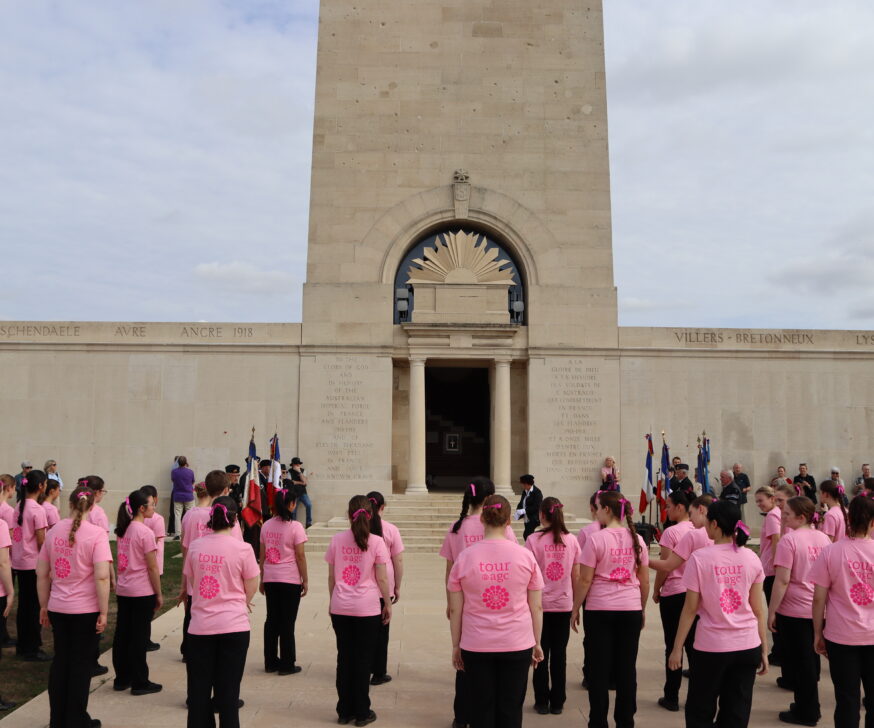 The singers and flag-bearers gathered at the foot of the memorial