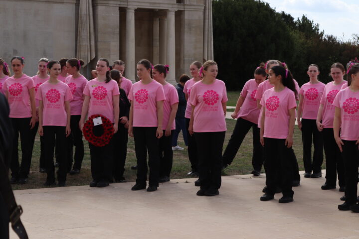 The choir members gathered in front of the memorial