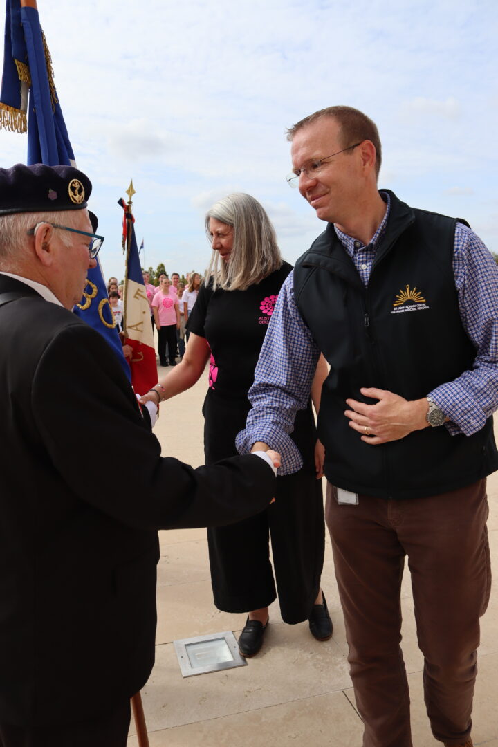 The director of the SJMC and the choir director greeting the flag-bearers