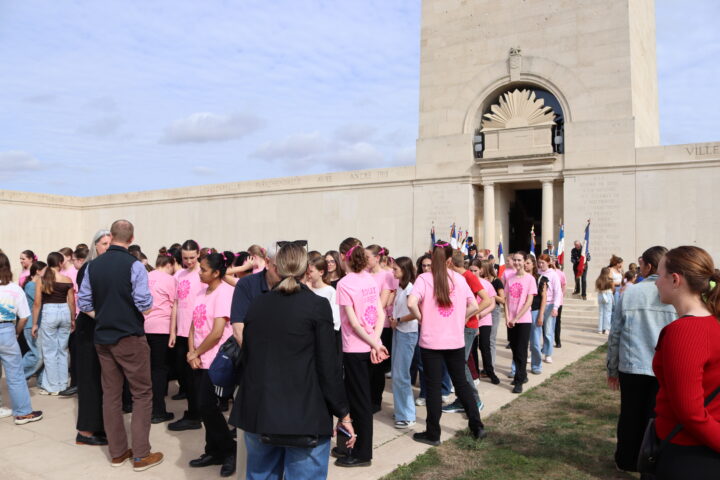 The choir members gathered at the foot of the memorial